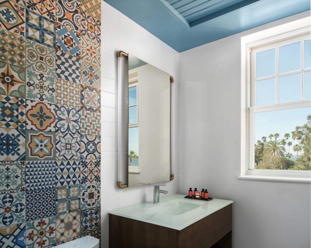 Colorful mosaic tile wall in a bathroom on a Fenway Hotel suite.