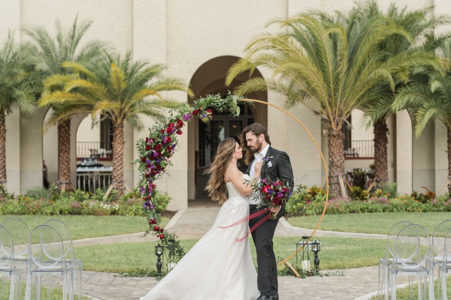 A person in a suit and person in a wedding dress staring at each other