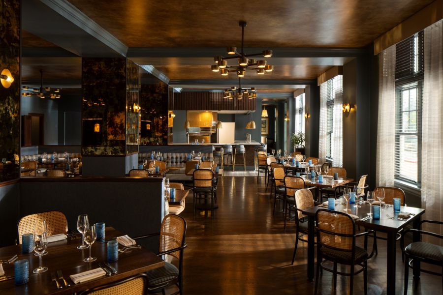 A restaurant with tables and chairs at HEW Parlor and Chophouse in Fenway Hotel